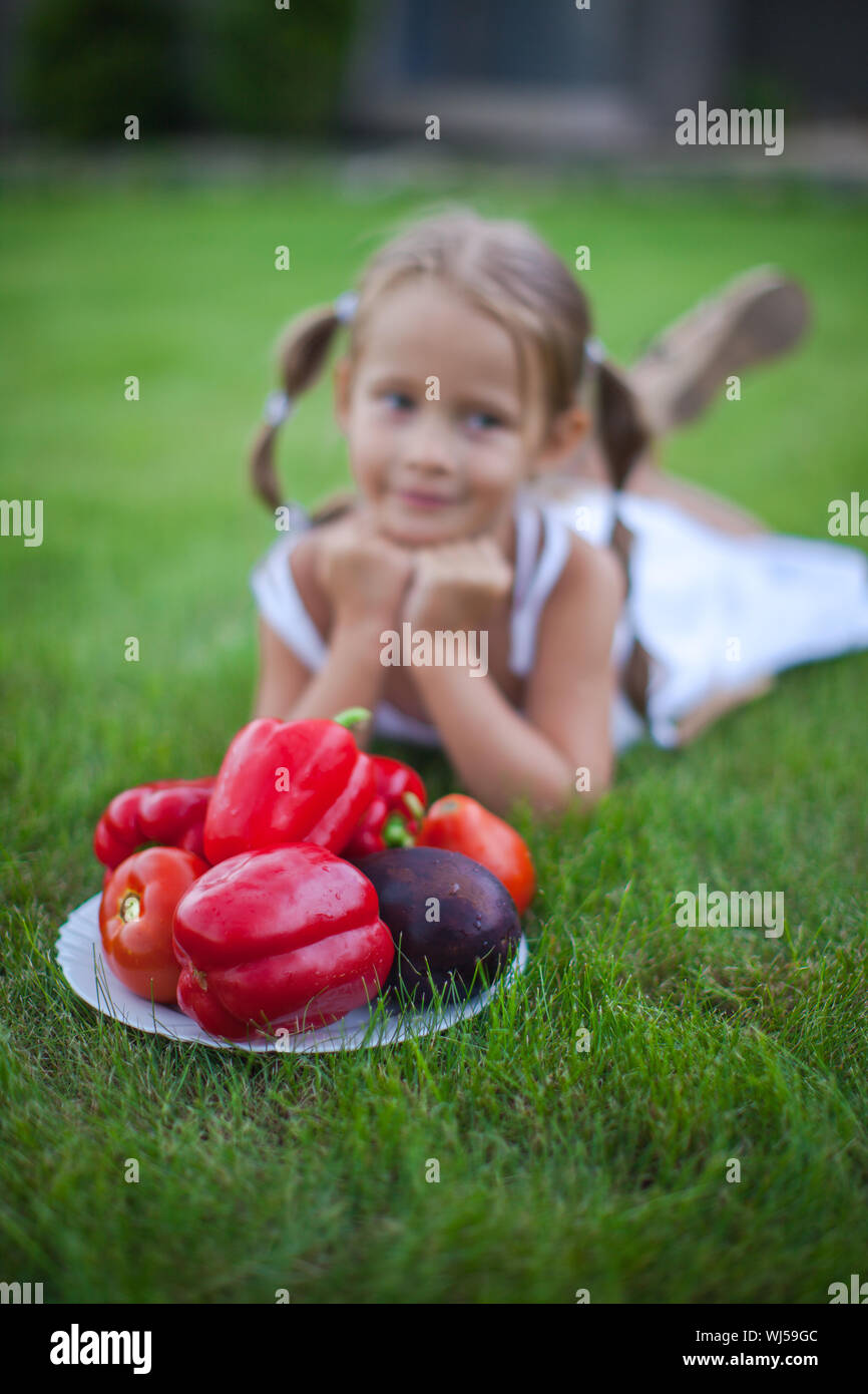 Little girl in garden with a plate of vegetables Stock Photo - Alamy