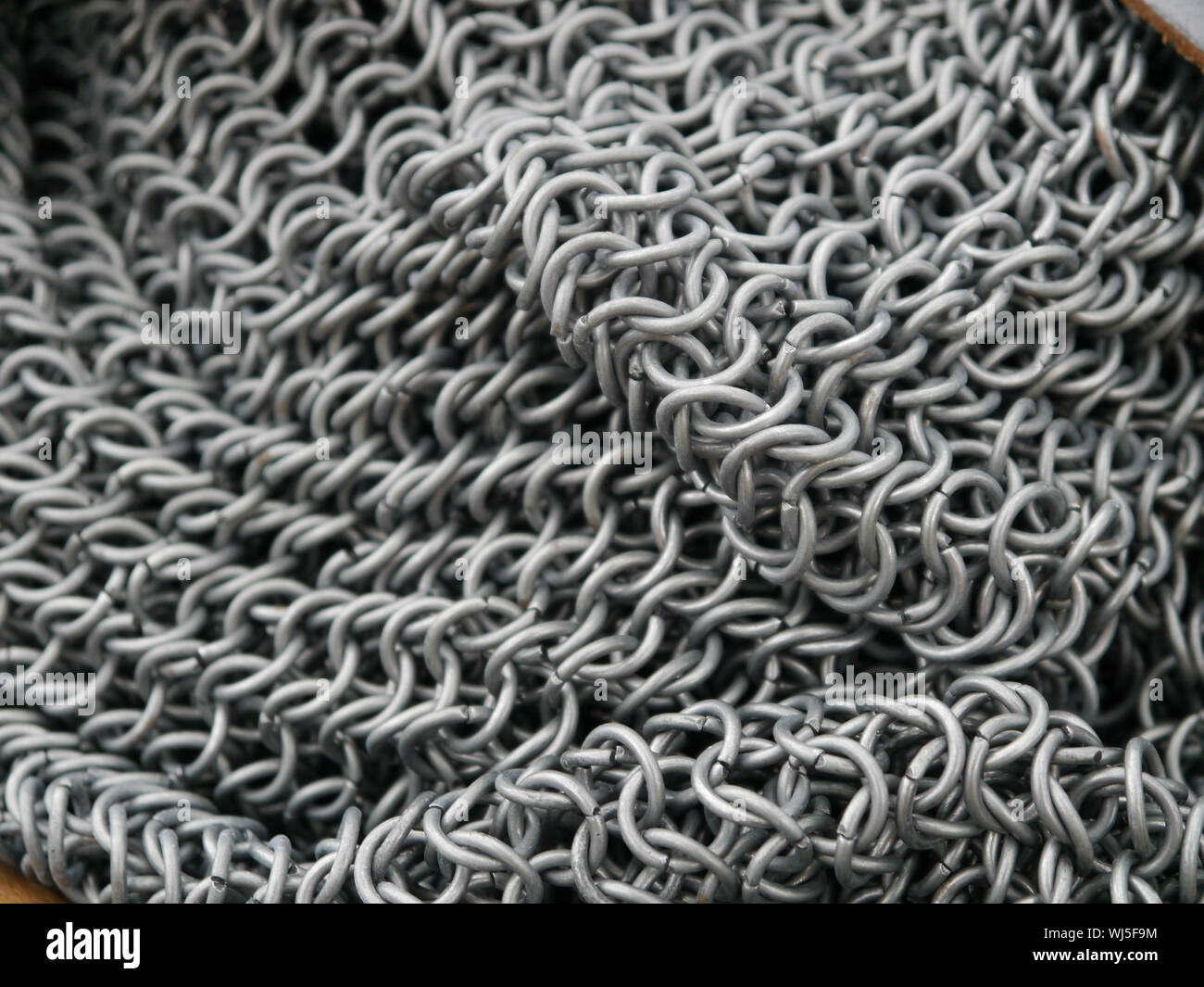 https://c8.alamy.com/comp/WJ5F9M/close-up-of-the-links-that-make-up-chain-mail-armour-WJ5F9M.jpg
