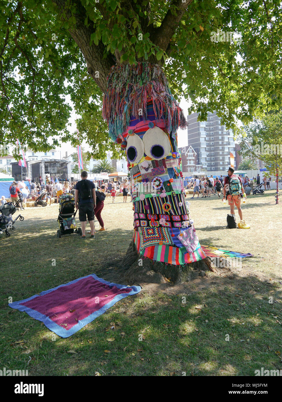 A tree is covered in knitted decorations in a display of Yarn Bombing Stock Photo