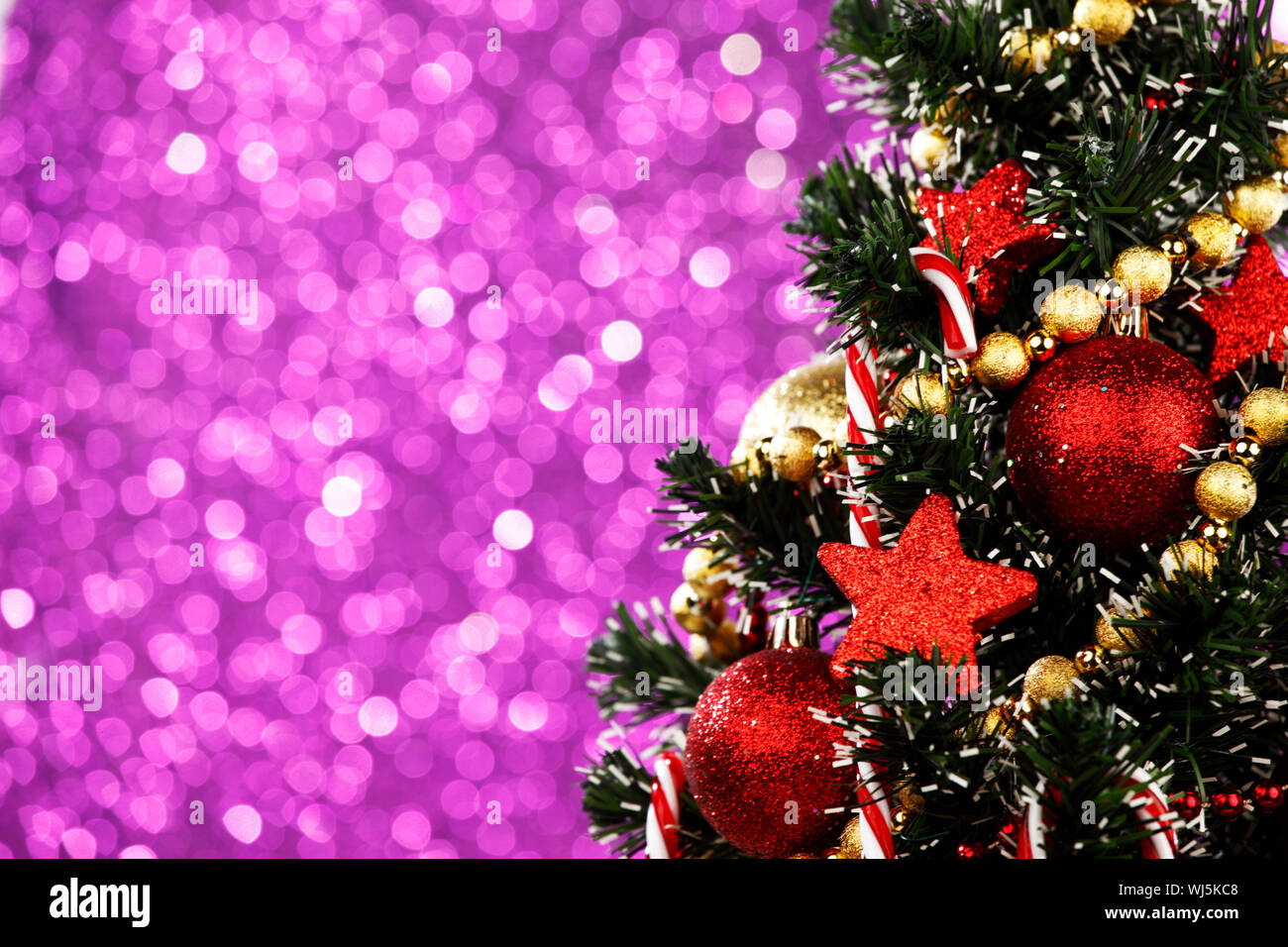 Beautiful decorated Christmas tree on glitter background Stock Photo ...