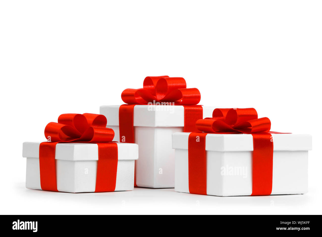 Gift boxes with red ribbon bows on white background Stock Photo - Alamy