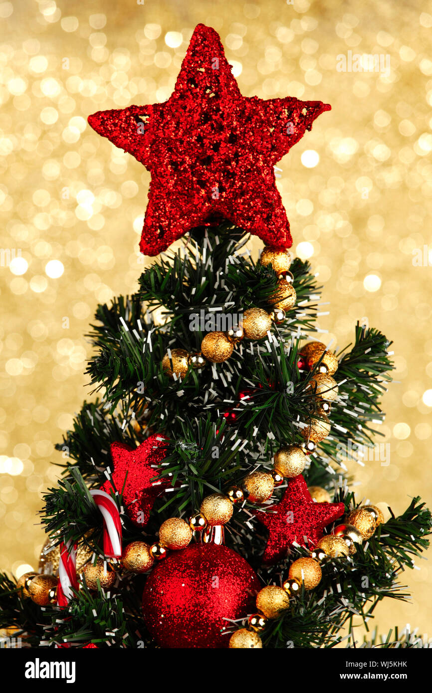 Beautiful decorated Christmas tree on glitter background Stock Photo