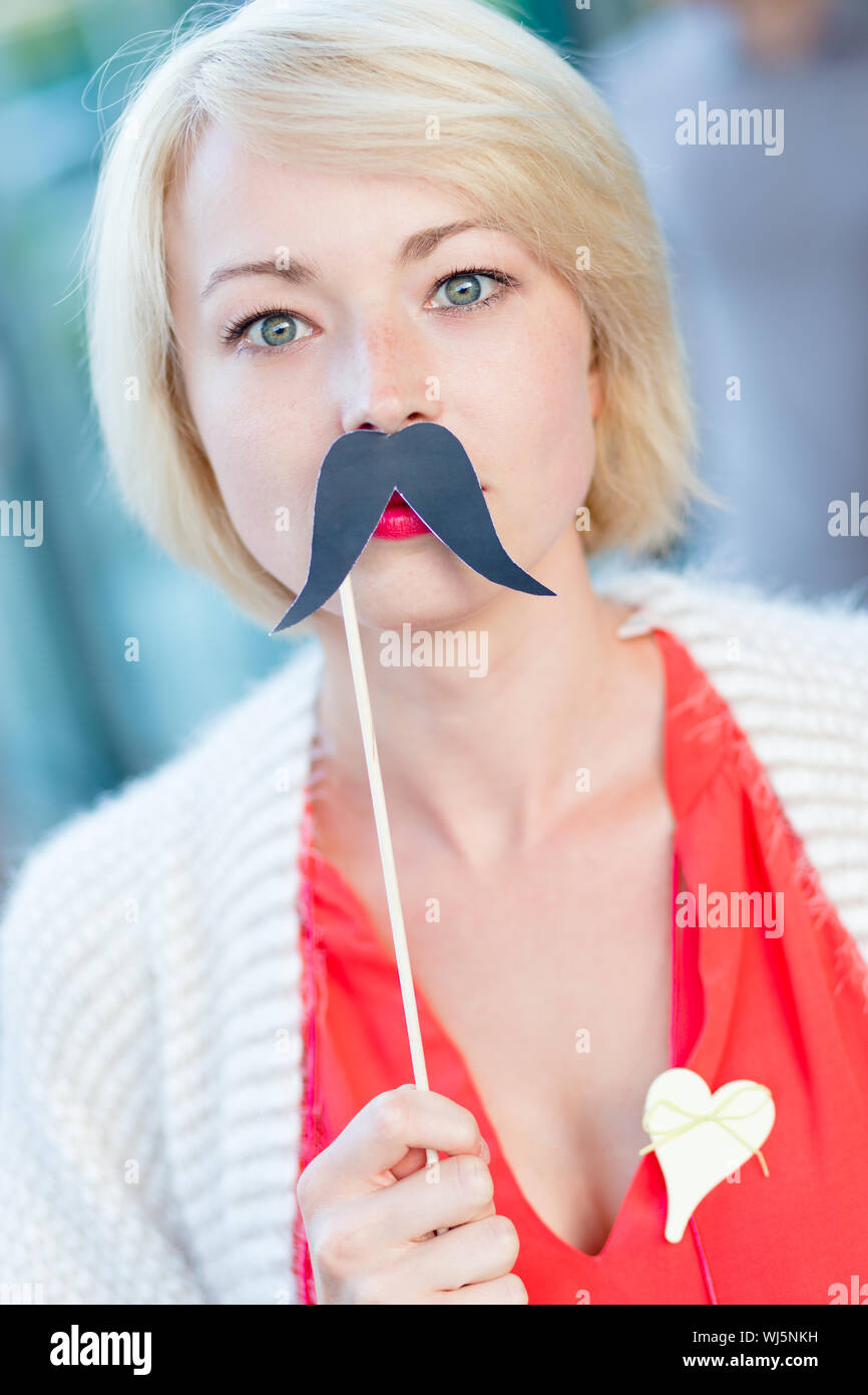 Woman wearing fake moustache hi-res stock photography and images - Alamy