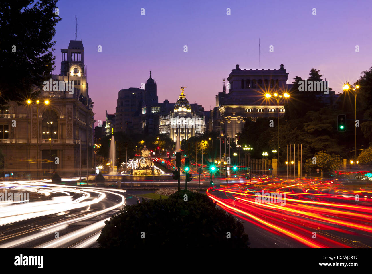Rays of traffic lights on Calle de Alcala street and Cibeles square in Madrid at night. Spain. Stock Photo