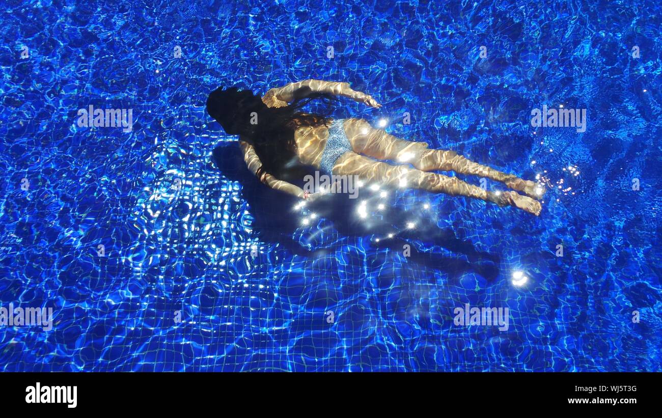 Rear view young woman swimming pool hi-res stock photography and images ...