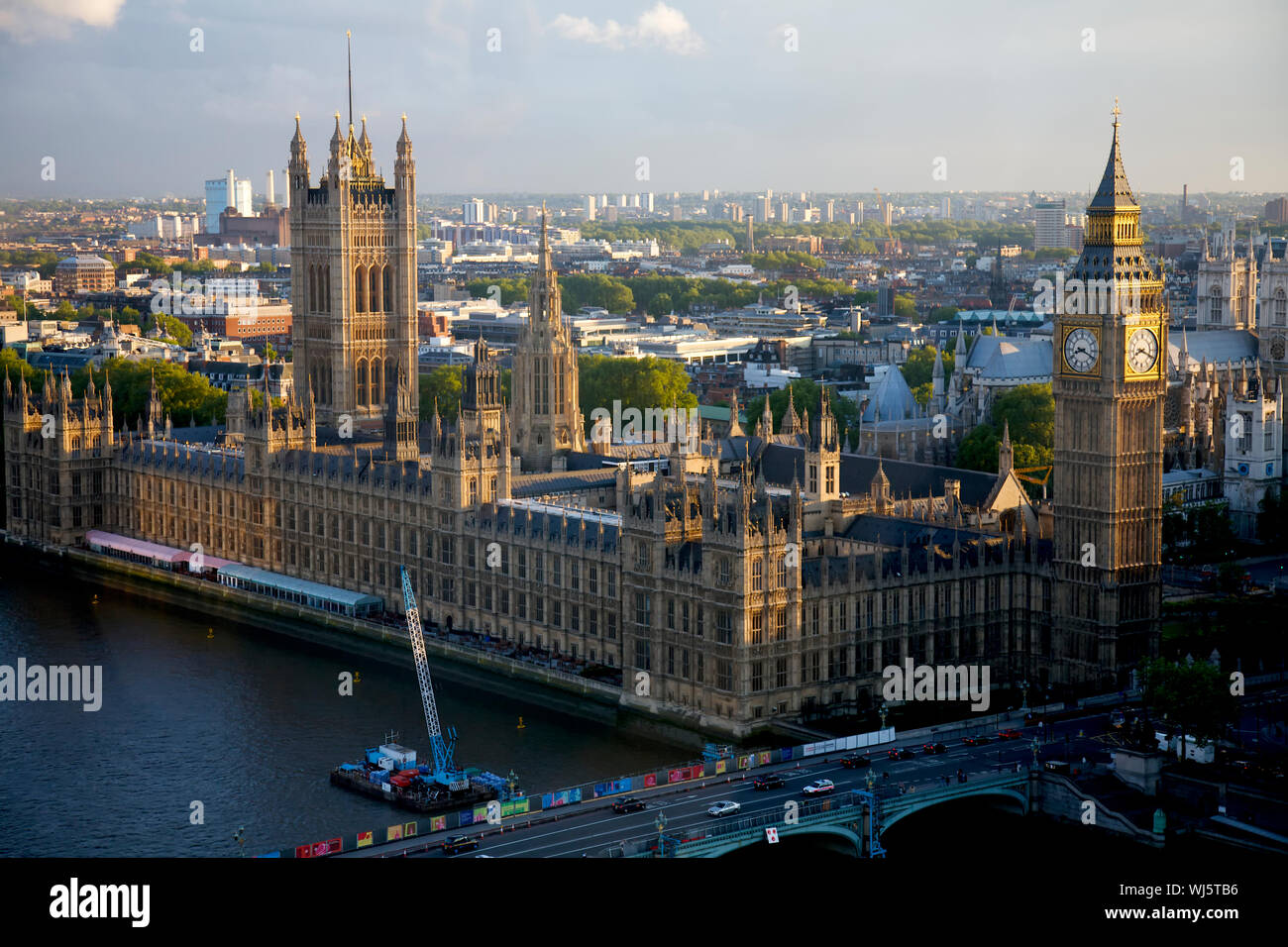 Westminster Palace And Bridge By Thames River In City Stock Photo