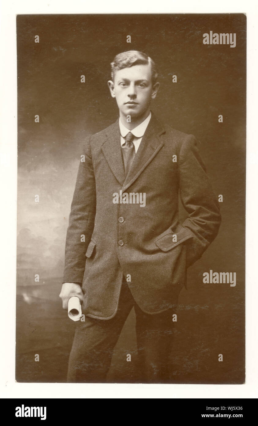 Early 1900s B&W studio photo of young boy in suit, holding certificate Early 1900s B&W studio photo of young boy in suit, holding certificate