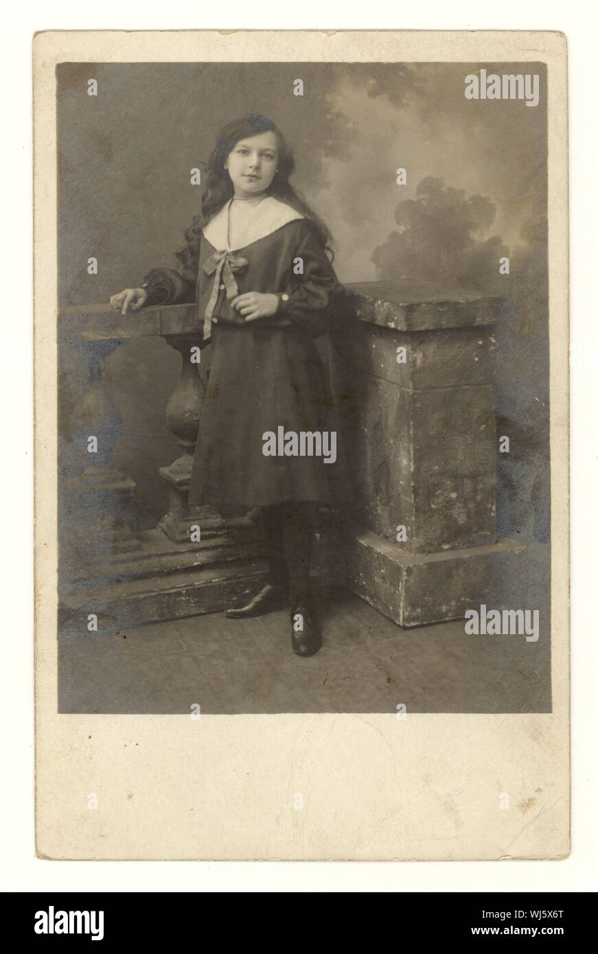 Early 1900's studio portrait postcard of pretty young girl with long hair wearing a sailor suit, circa 1904, U.K. Stock Photo