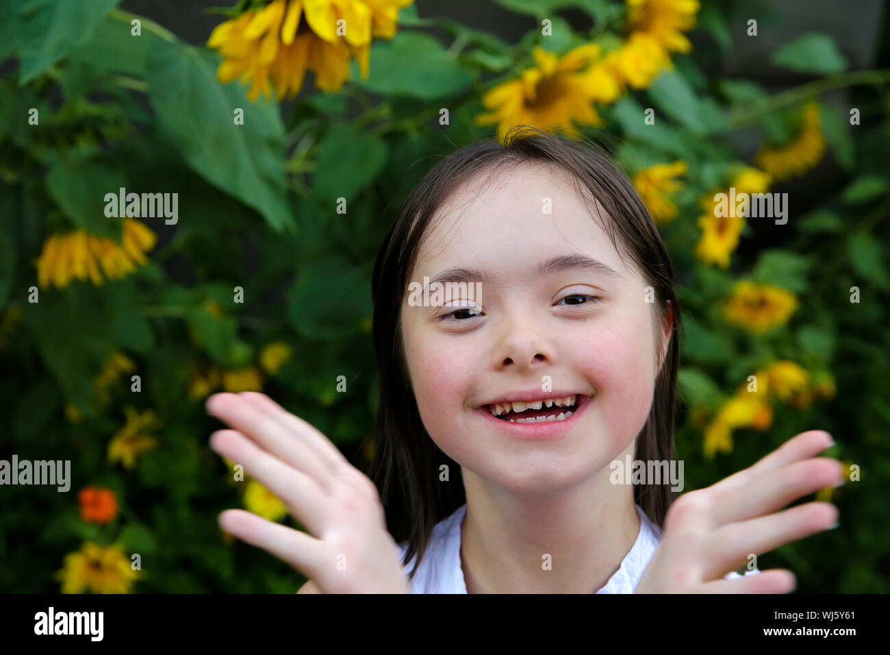 Portrait of little girl smiling in the garden Stock Photo - Alamy