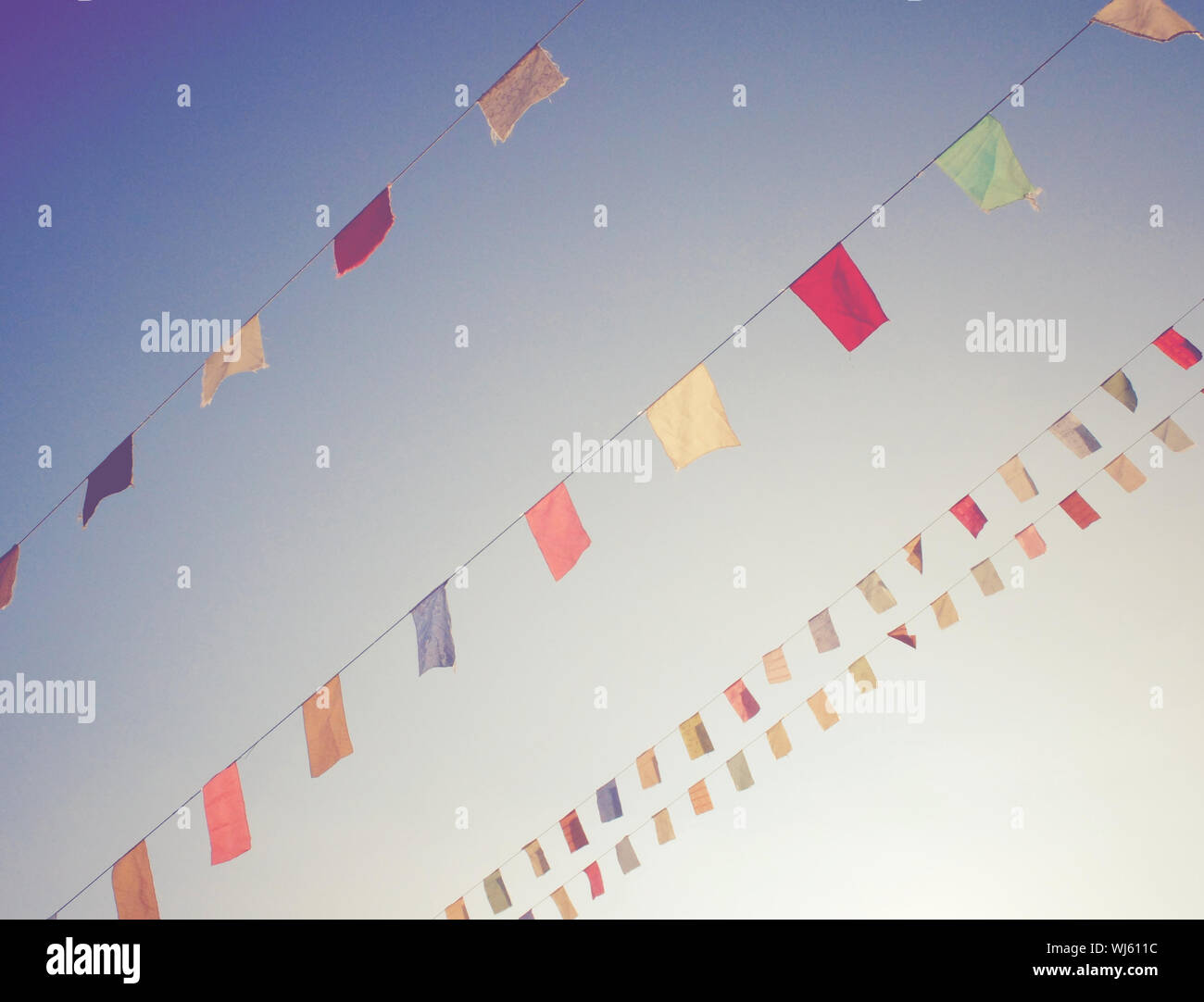 Colorful bunting flags on blue sky with retro filter effect Stock Photo ...