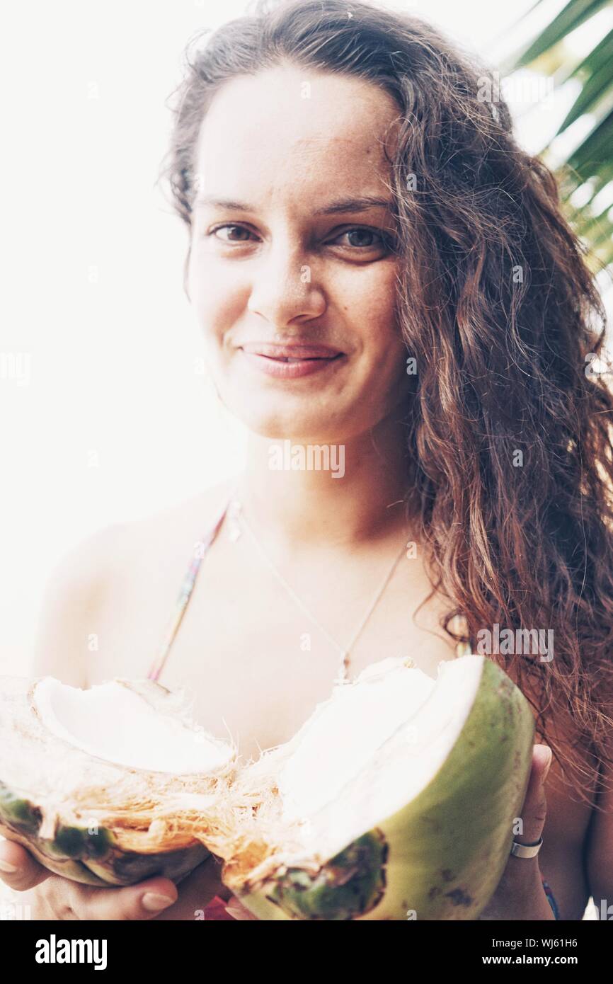 Close up of woman holding coconut hires stock photography and images