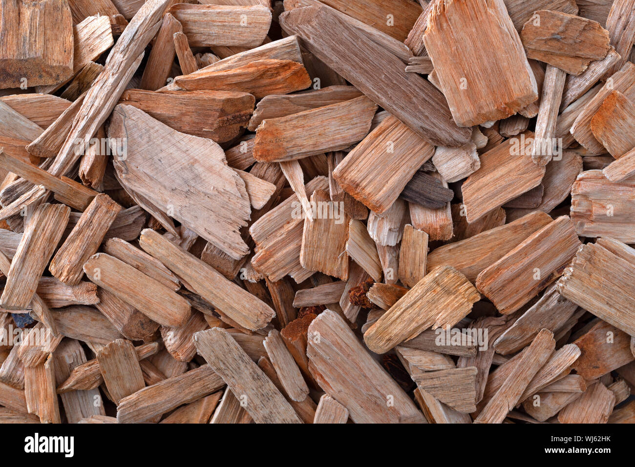 Overhead view of a group of alder smoking chips illuminated with natural lighting. Stock Photo
