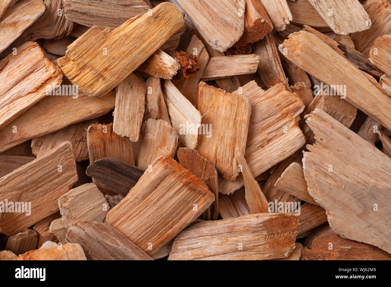 Close view of a group of alder smoking chips illuminated with natural lighting. Stock Photo