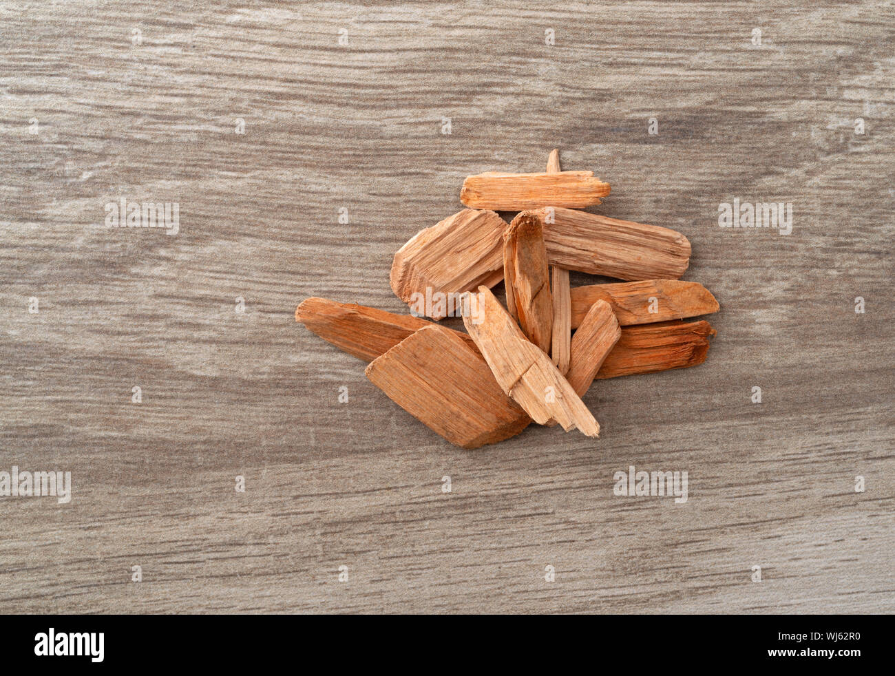 Small pile of alder wood smoking chips for barbecuing on a tile counter top. Stock Photo