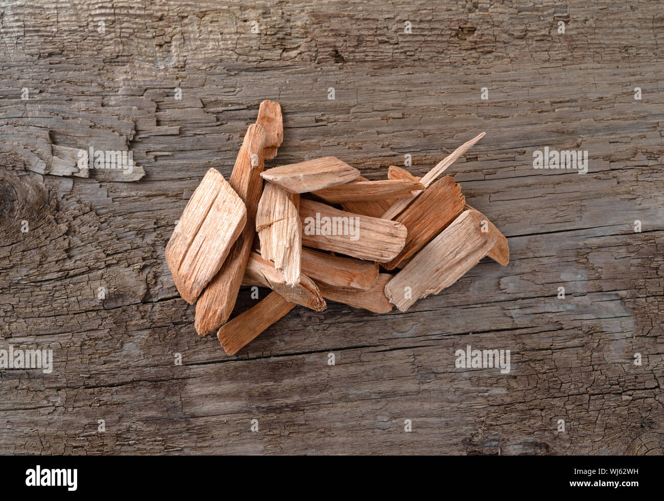 Small pile of alder wood smoking chips for barbecuing on a weathered background. Stock Photo