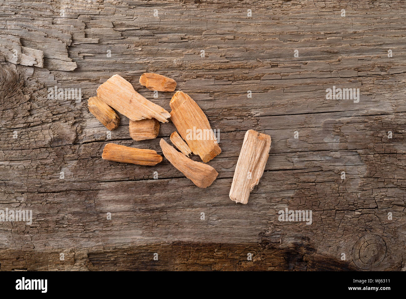 Small group of alder wood smoking chips for barbecuing on a weathered background. Stock Photo