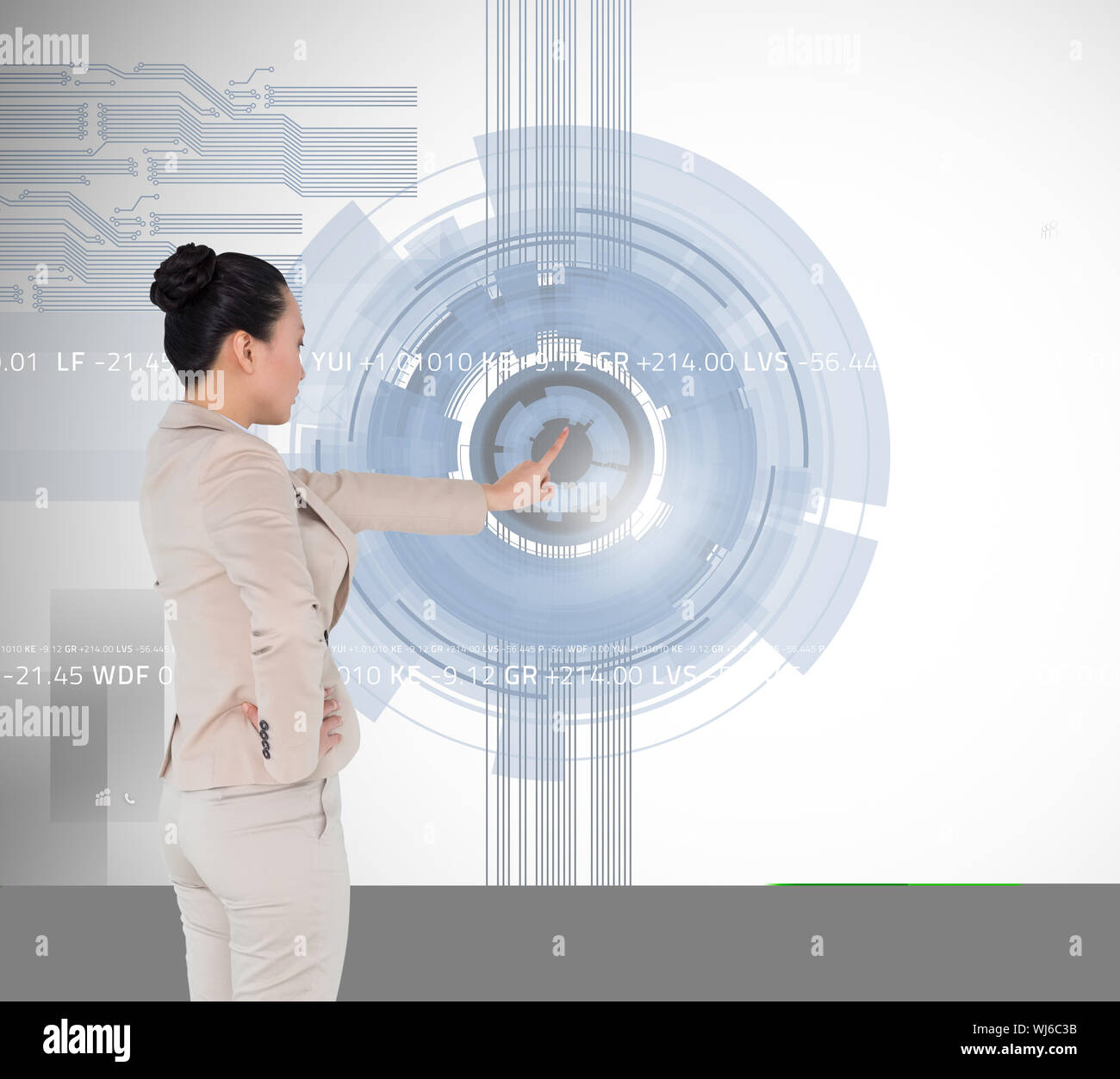 Composite image of unsmiling asian businesswoman pointing Stock Photo