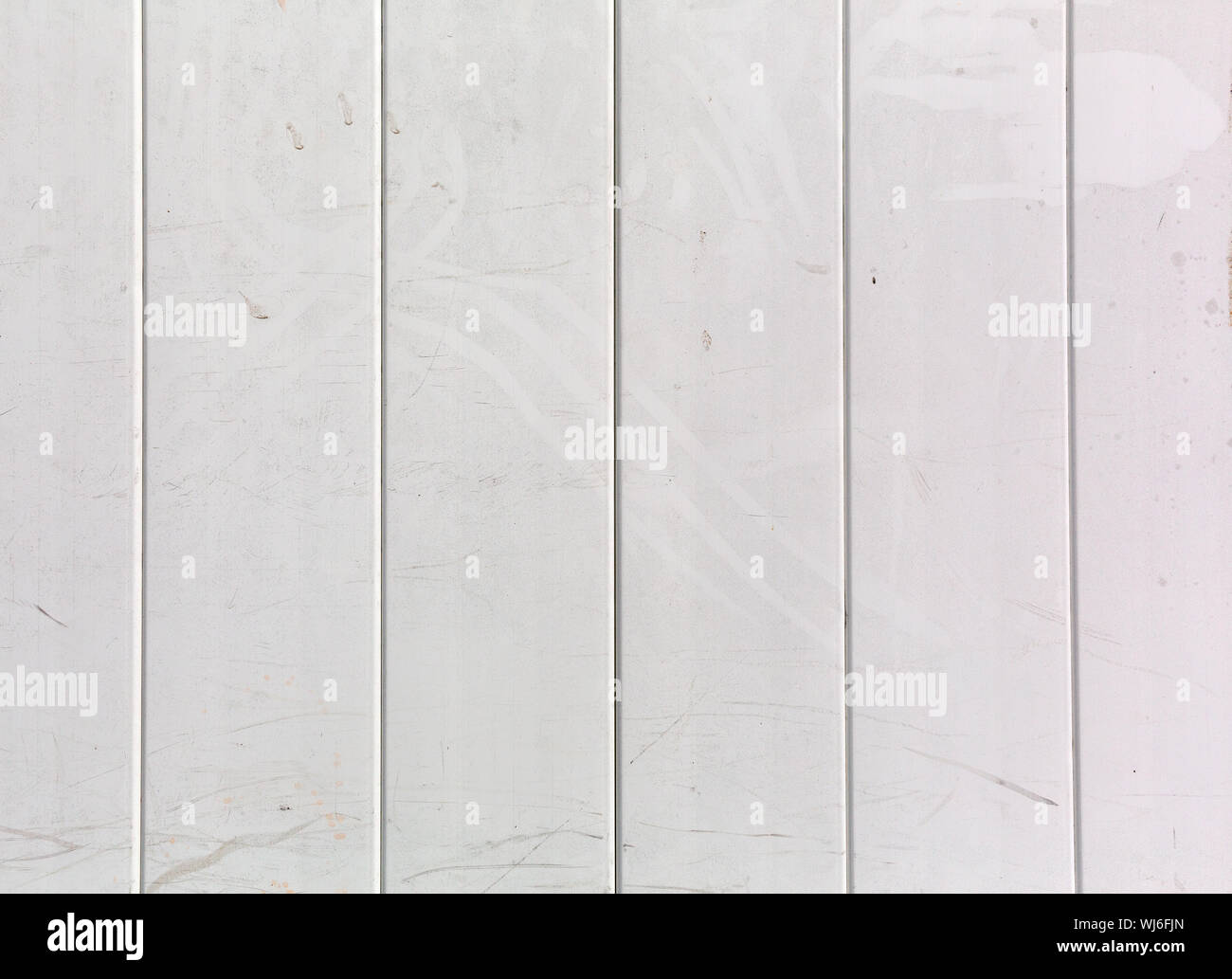 Several rows of dirty vinyl fencing with stains and fingerprints Stock