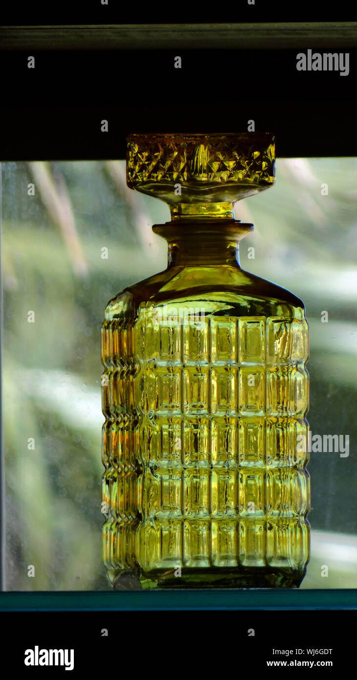 Close-up Of Antique Green Glass Bottle On Shelf At Store Stock Photo