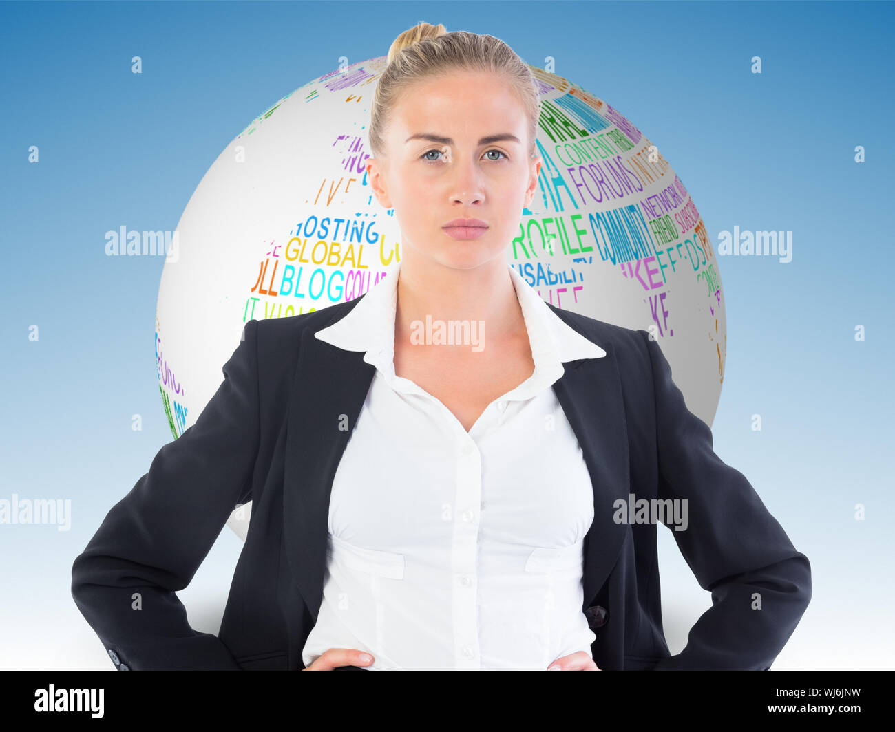 Composite image of blonde businesswoman standing with hands on hips Stock Photo