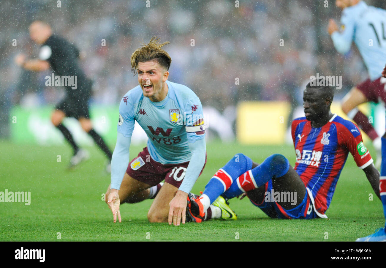 Jack Grealish of Aston Villa goes down under a challenge from Cheikhou Kouyate of Crystal Palace during the Premier League match between Crystal Palace and Aston Villa at Selhurst Park , London , 31 August 2019 - Editorial use only. No merchandising. For Football images FA and Premier League restrictions apply inc. no internet/mobile usage without FAPL license - for details contact Football Dataco Stock Photo