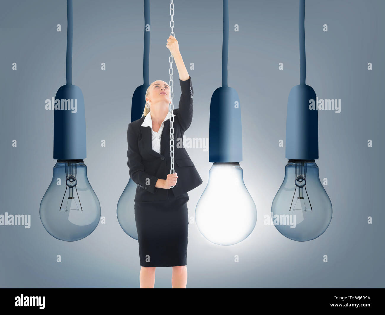 Composite image of blonde businesswoman pulling a chain Stock Photo - Alamy