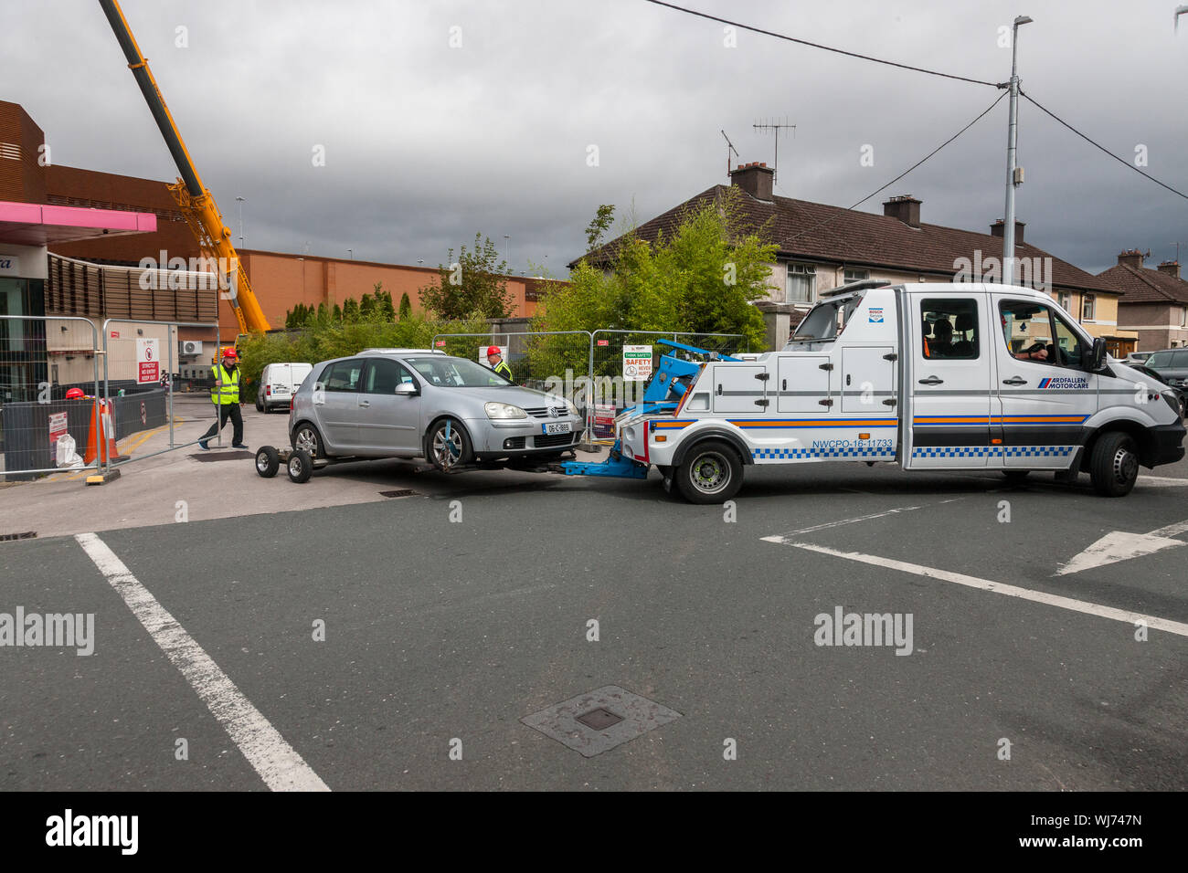 Douglas, Cork, Ireland. 03rd Sep, 2019. The first car to be recovered from the Douglas Shopping Centre Car Park been removed from the site after it was lifted off the roof where over 100 cars have been trapped after a major fire in the multi-storey car park over the weekend. Recovery of the vehicles will take over a week and the building will then be demolished. - Picture; Credit: David Creedon/Alamy Live News Stock Photo