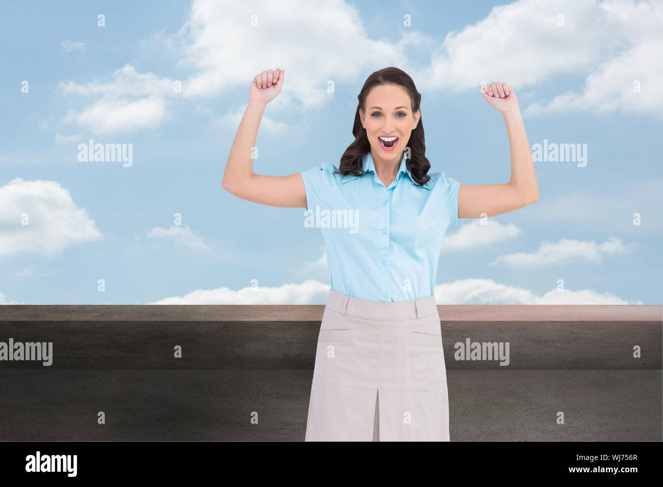 Composite image of victorious stylish businesswoman posing Stock Photo