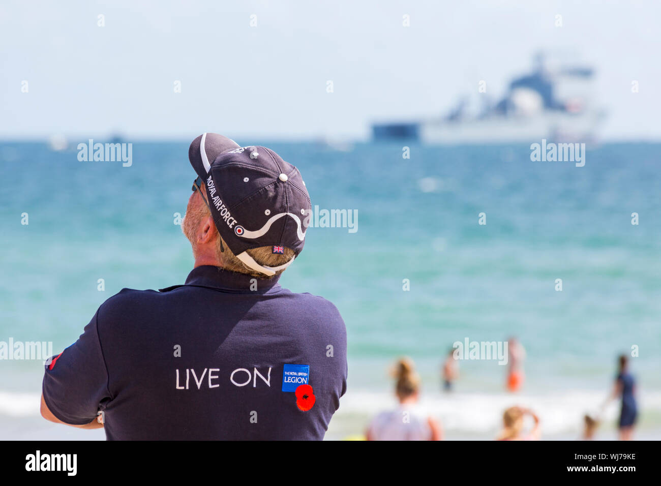 Man wearing t-shirt with Live On The Royal British Legion on the back & Royal Air Force baseball cap at Bournemouth Air Festival, Dorset UK in August Stock Photo