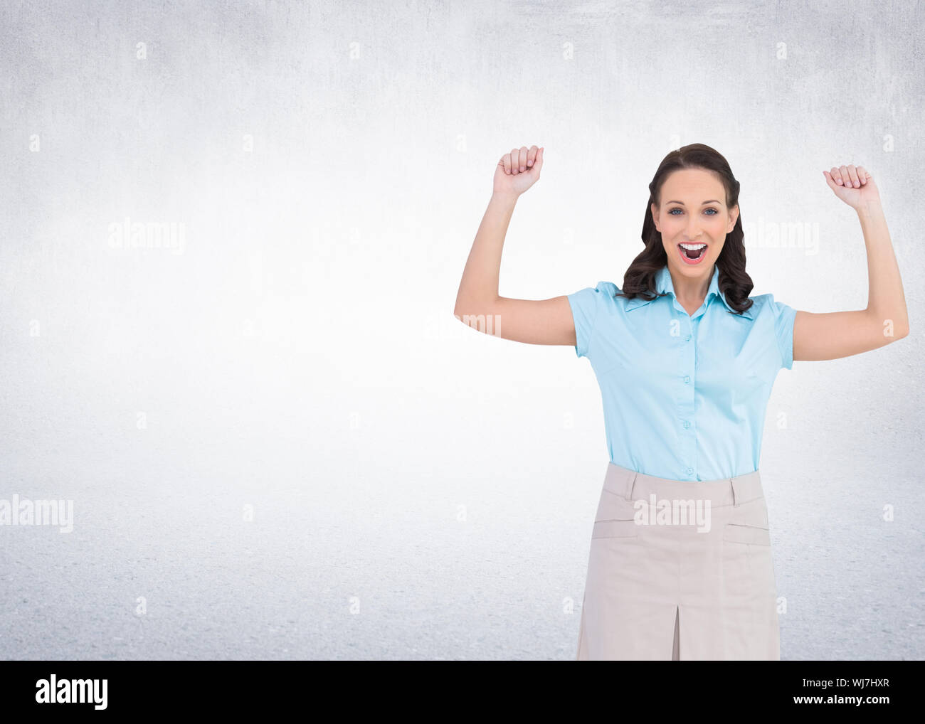 Composite image of victorious stylish businesswoman posing Stock Photo