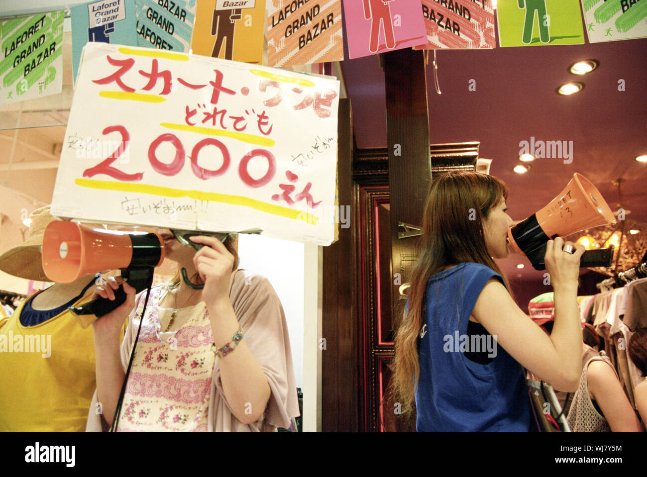 Shop workers try to attract shoppers to their stalls in the La Floret Store,  Harajuku Distric, Tokyo, Japan. Stock Photo