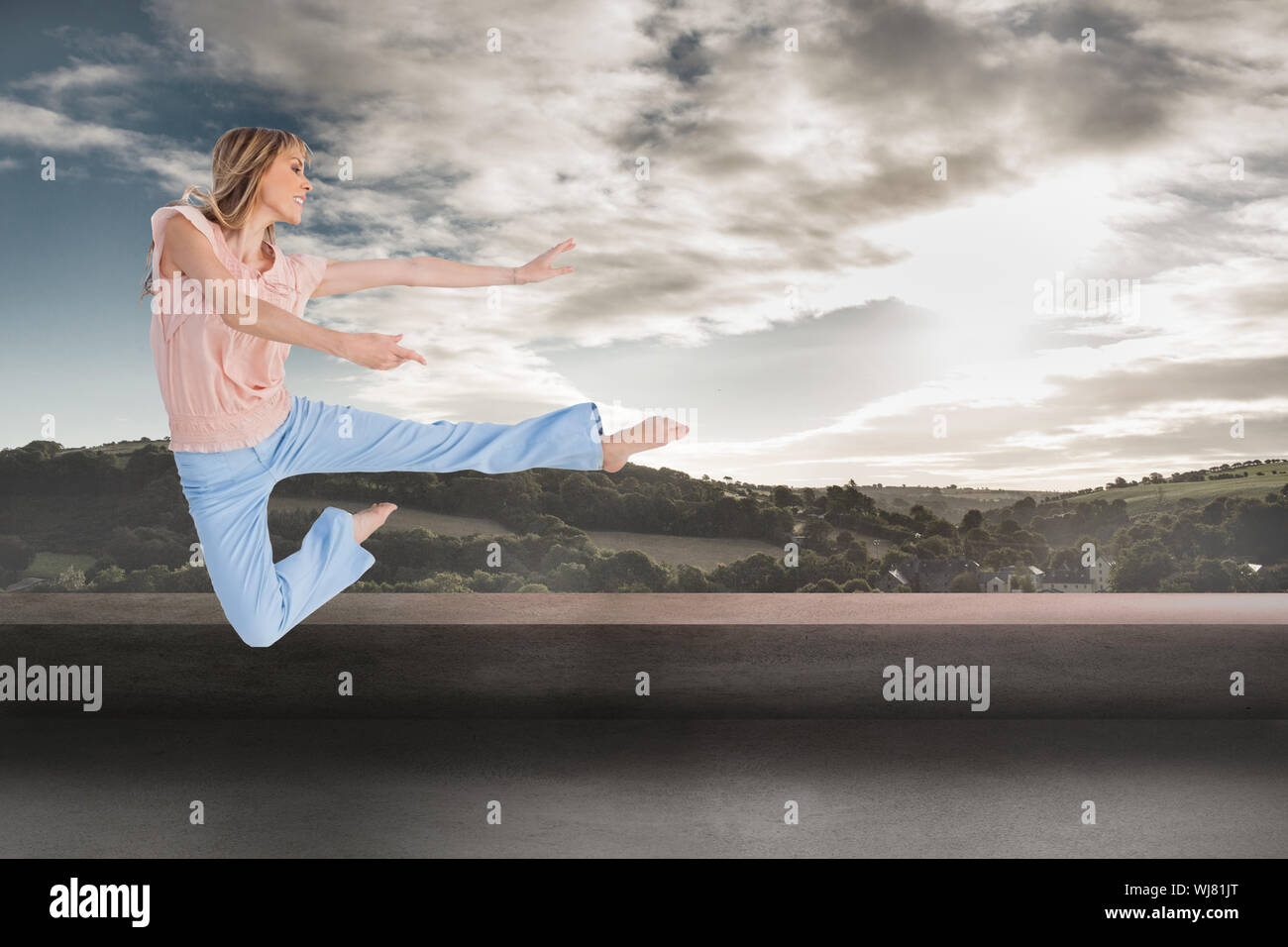 Composite image of woman doing dance pose Stock Photo