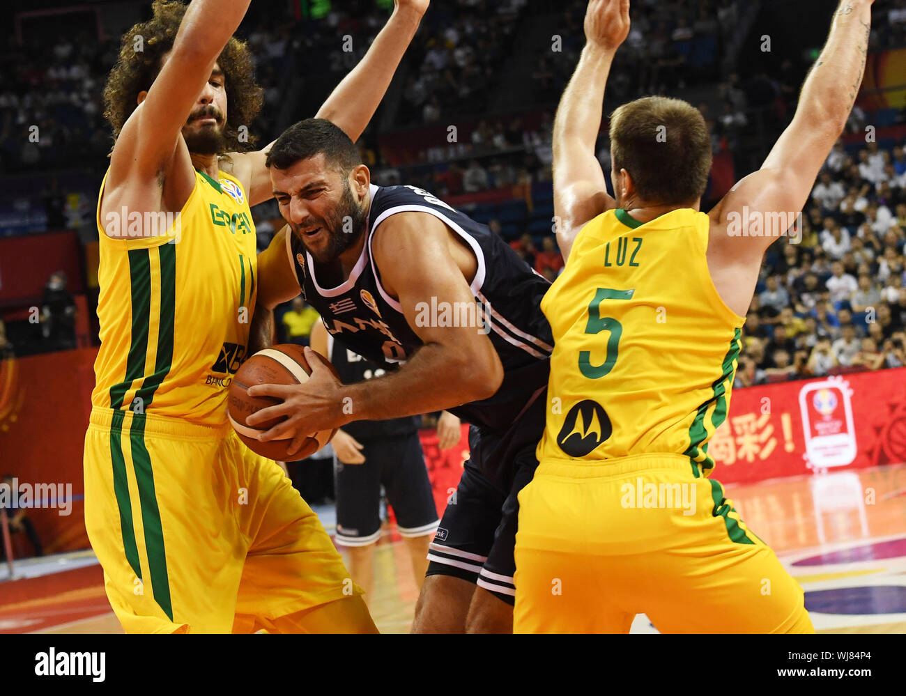 Nanjing, China's Jiangsu Province. 3rd Sep, 2019. Ioannis Bourousis (C) of  Greece breaks through past Rafa Luz (R) and Anderson Varejao of Brazil  during the group F match between Greece and Brazil