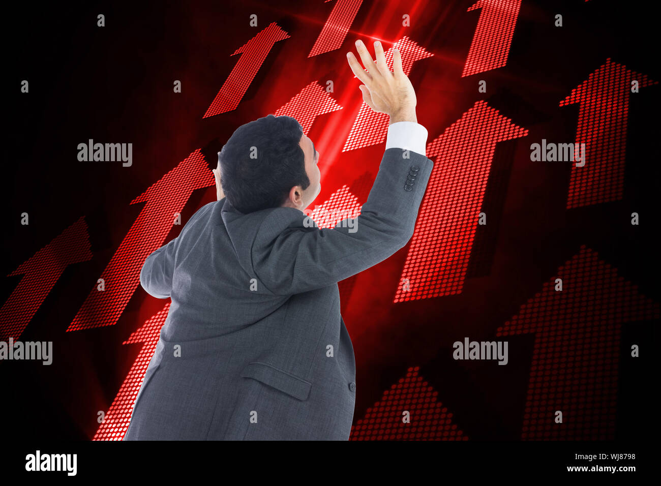 Composite image of businessman with arms raised Stock Photo - Alamy
