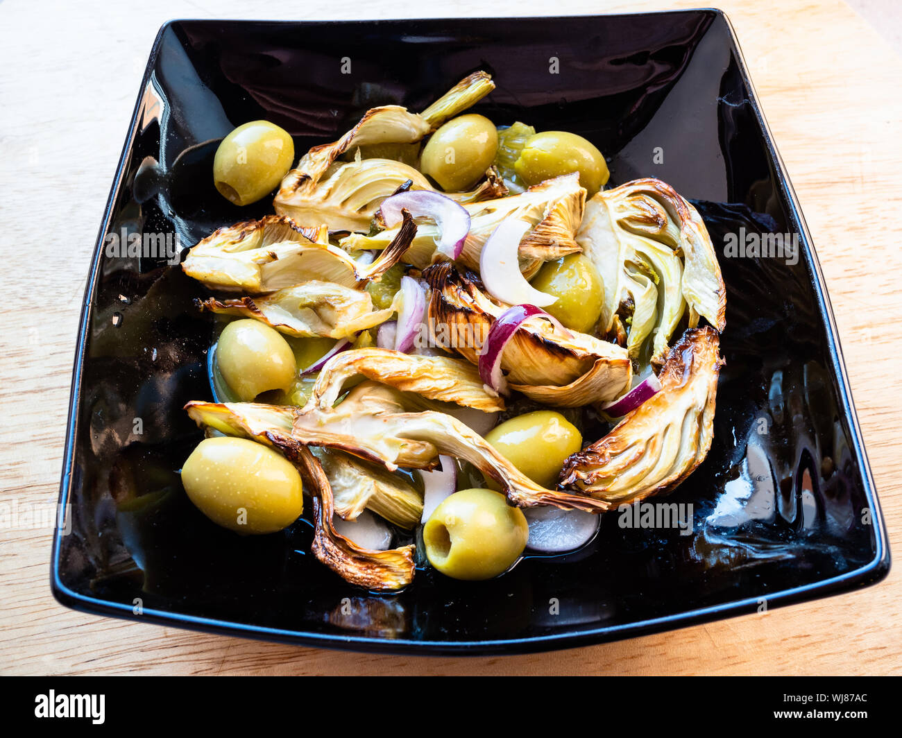 french cuisine baked fennel stalk with olives and red onion and