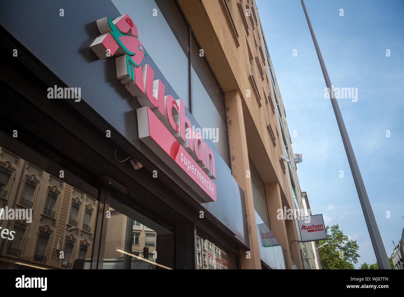 LYON, FRANCE - JULY 18, 2019: Auchan logo in front of their local supermarket in Lyon. Auchan is a French retailer of supermarkets and hypermarkets sp Stock Photo
