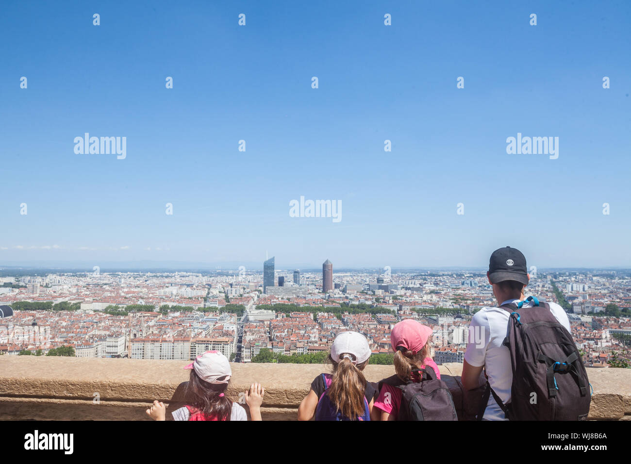 LYON, FRANCE - JULY 19, 2019: Aerial panoramic view of Lyon with children tourists pointing at the skyline and the Incity tower and Le Crayon during a Stock Photo
