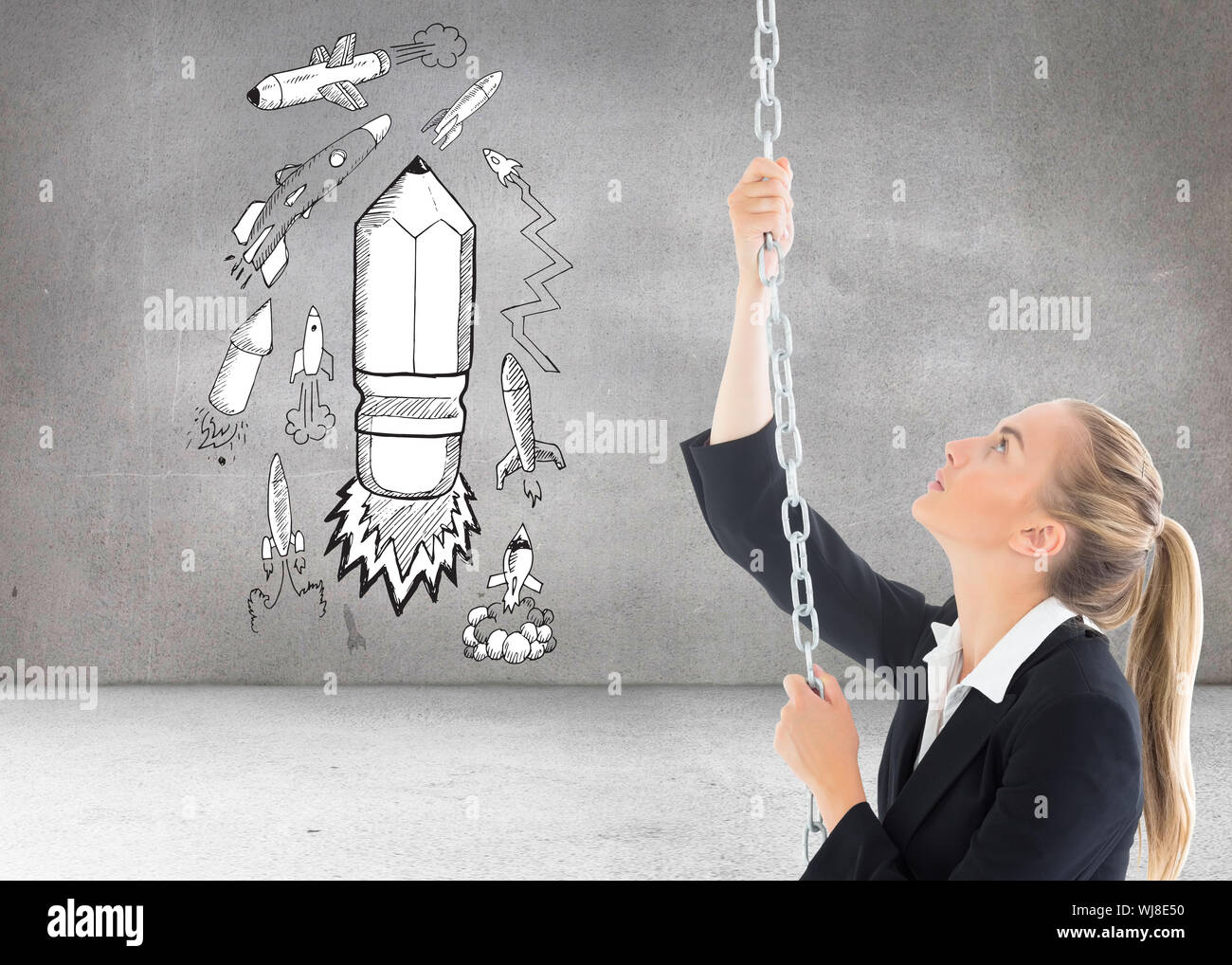 Composite image of blonde businesswoman pulling a chain Stock Photo - Alamy