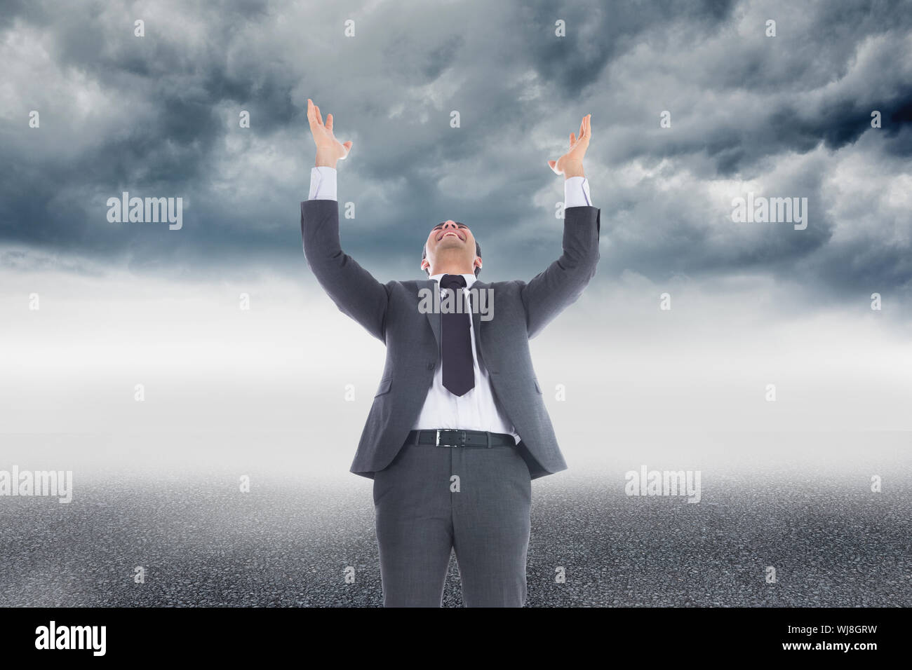 Composite image of businessman with arms raised Stock Photo - Alamy