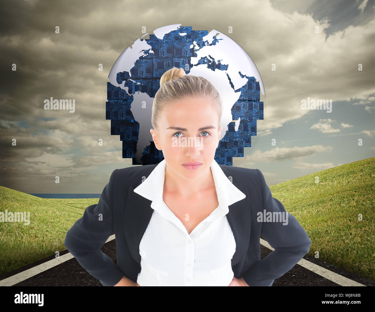 Composite image of blonde businesswoman standing with hands on hips Stock Photo
