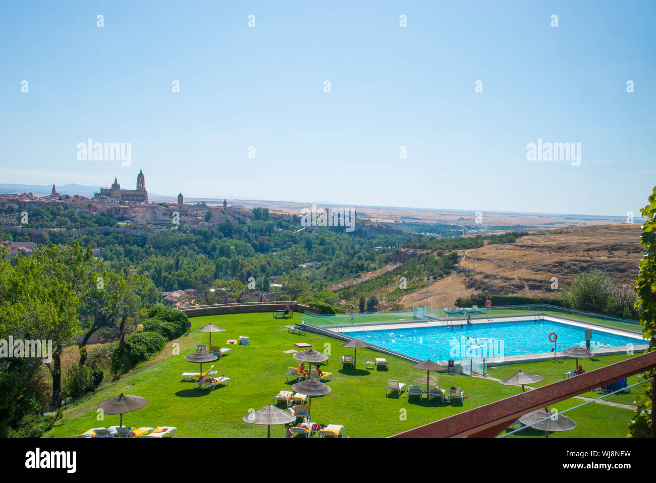 Swimming pool and garden of the parador and overview of the city. Segovia, Spain. Stock Photo