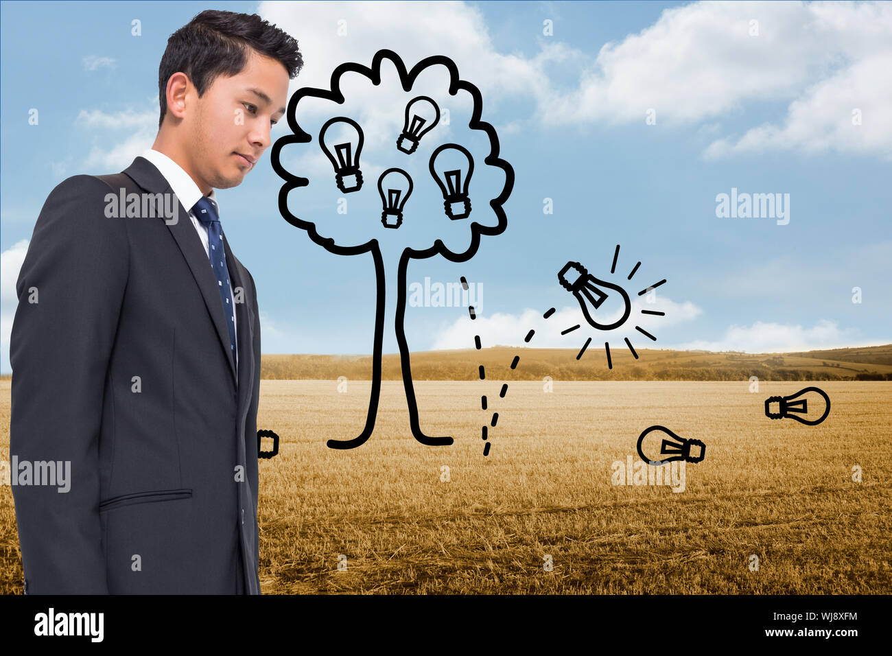 Composite image of light bulb tree over countryside Stock Photo