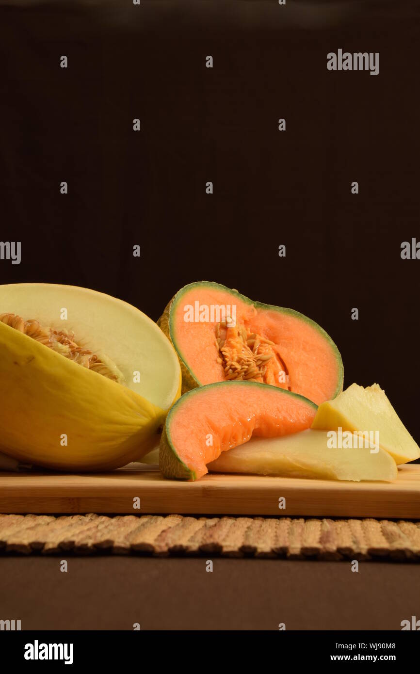 Ensemble of honeydew melon and cantaloup on dark background Stock Photo