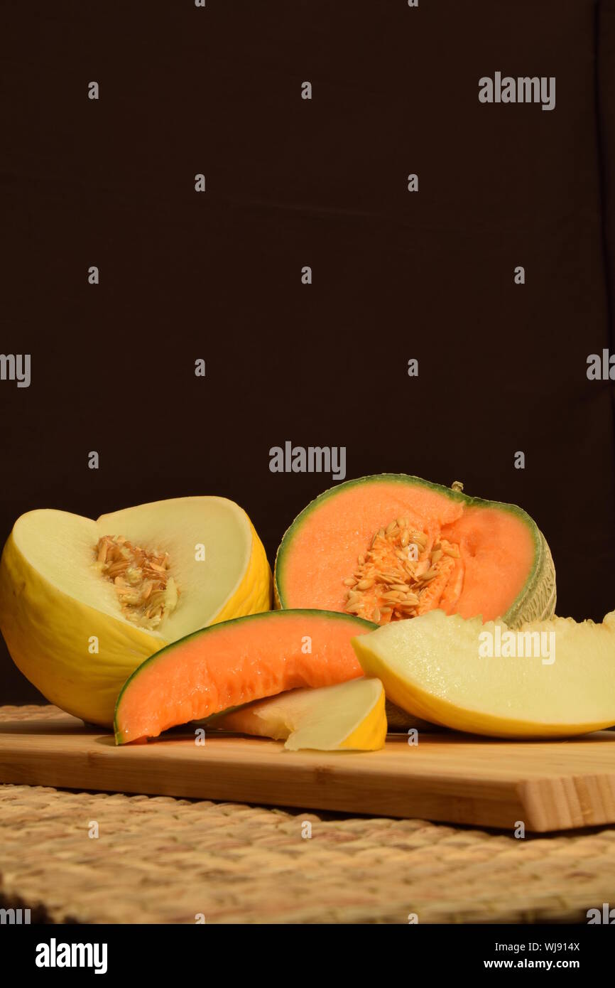 Ensemble of honeydew melon and cantaloup on dark background Stock Photo