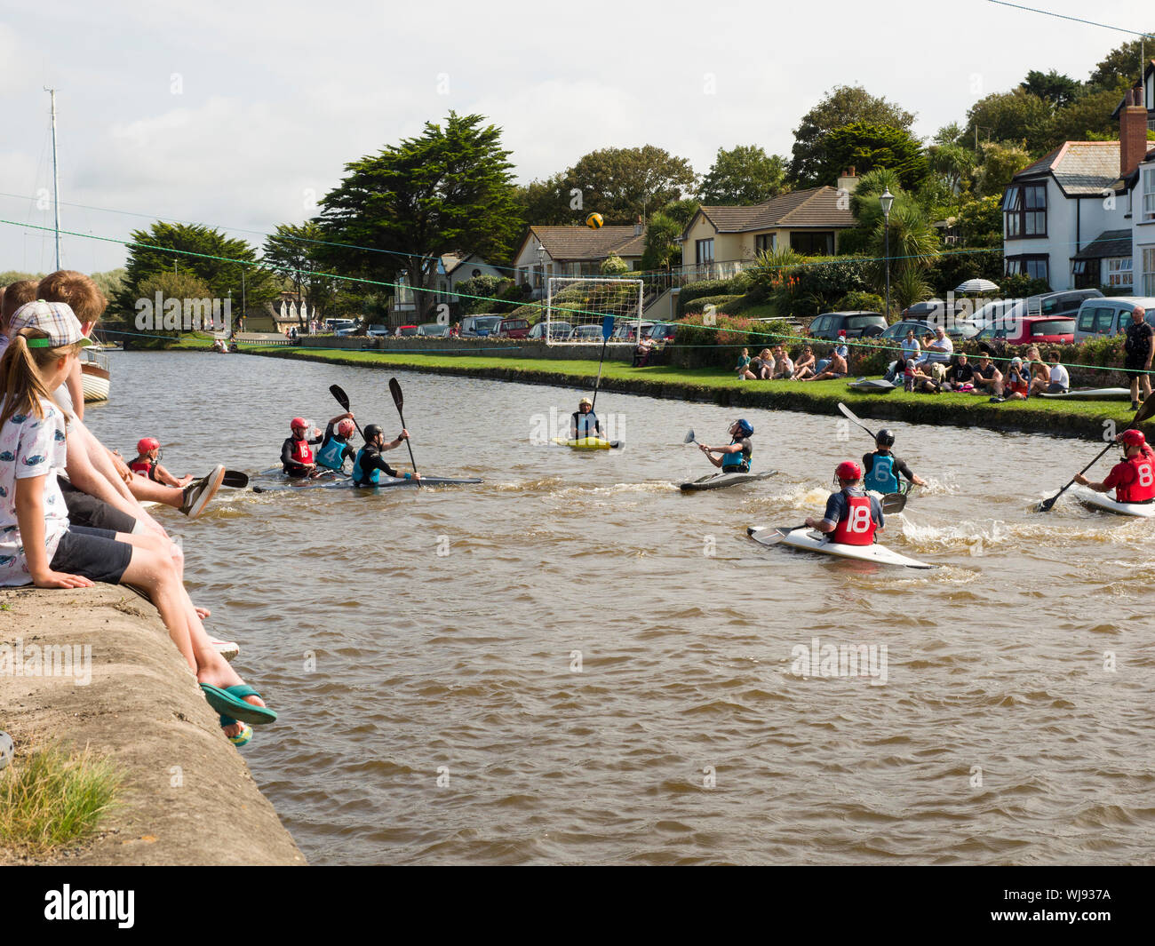 Children watching Canoe water polo on the Bude Canal, Cornwall, UK