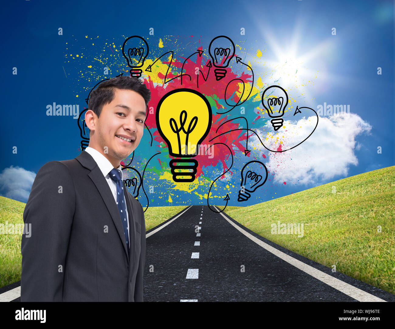Composite image of colourful light bulbs graphic on bright countryside Stock Photo