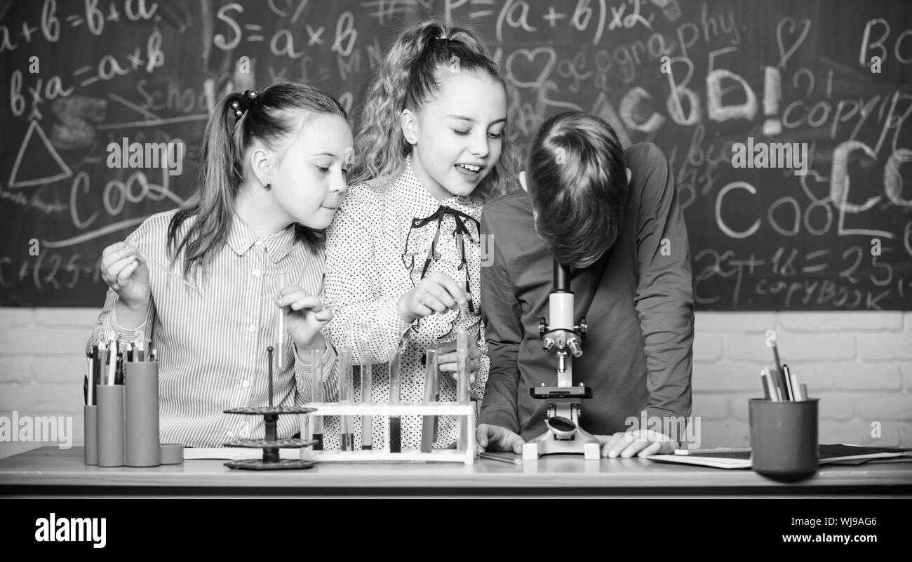 Chemistry science. Little kids earning chemistry in school lab. biology experiments with microscope. Little children. Science. Little girls and boy in lab. Smart and confident student. Stock Photo