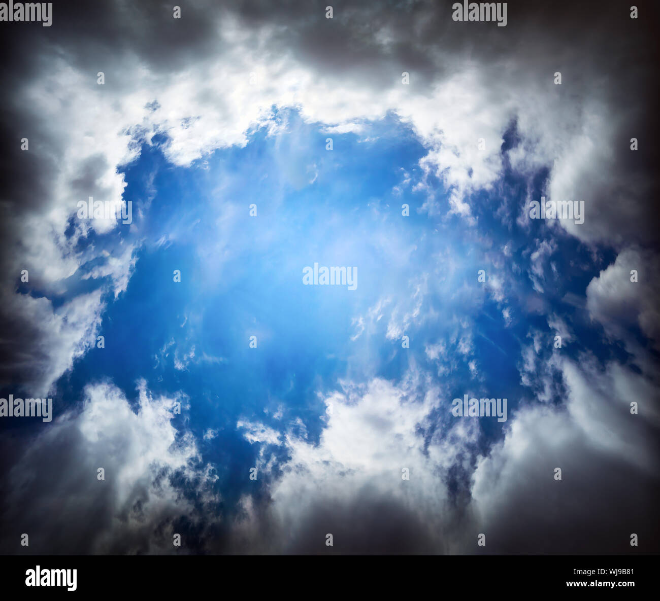 dramatic cloudscape with dark clouds and blue sky hole Stock Photo