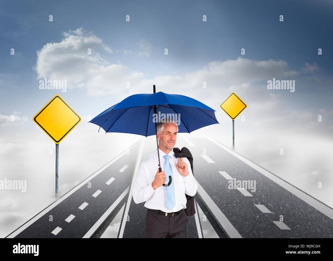 Composite image of mature businessman holding an umbrella standing on streets floating in the sky Stock Photo