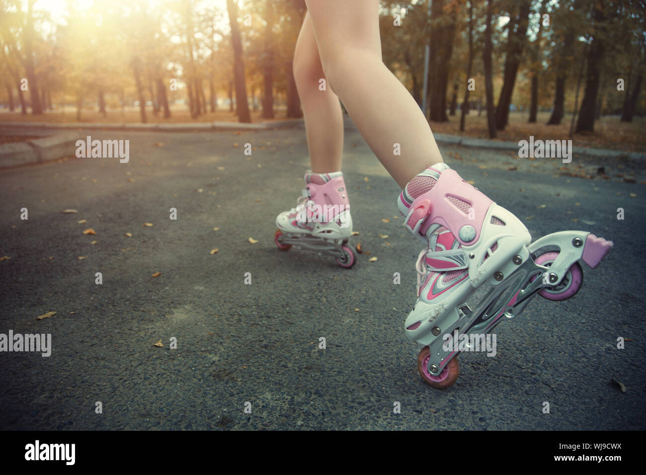 Legs of teenager having roller skate exercise in public park Stock